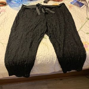 Flows lace pants with fabric belt.